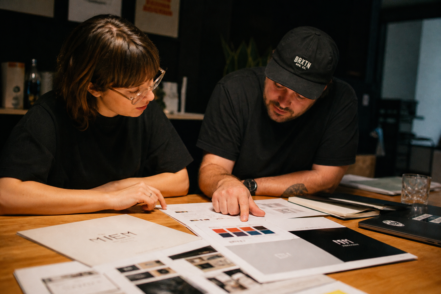 Team reviewing brand guidelines at the studio table